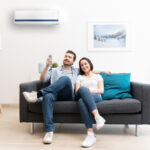 Happy,Couple,Freshen,Up,Using,Air,Conditioner,At,Home
