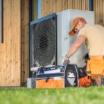 Hvac,Worker,Working,On,A,Modern,Heat,Pump,Outside,A