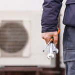 Heat,Pump,Heating,System,Installing,And,Maintenance.,Worker,Hand,With